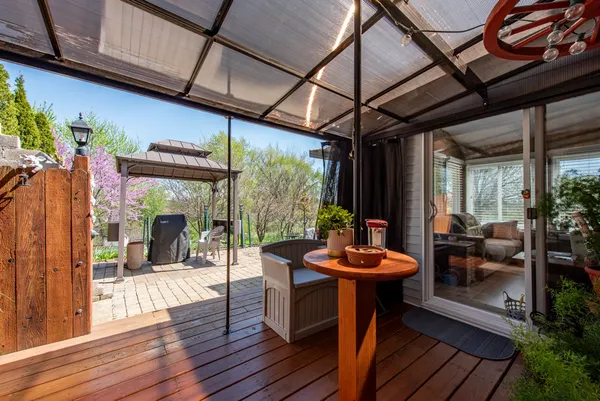 a view of a patio with a table chairs and a yard