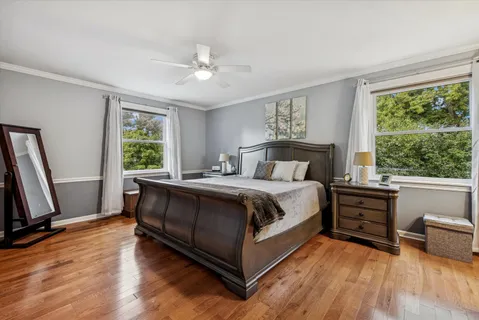 a bedroom with a bed and a large window