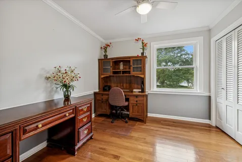 a view of a workspace with furniture and a window