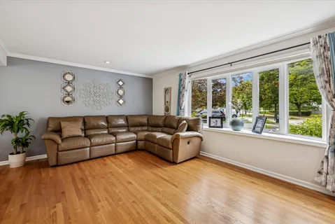 a living room with furniture and large windows