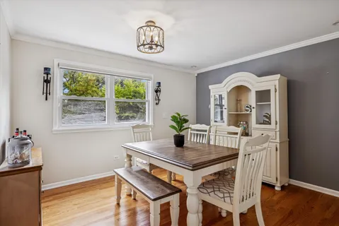 a dining room with furniture and window
