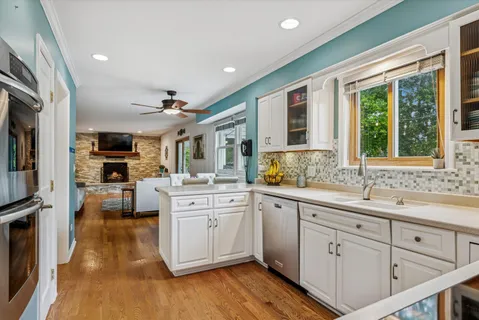 a kitchen with white cabinets and stainless steel appliances