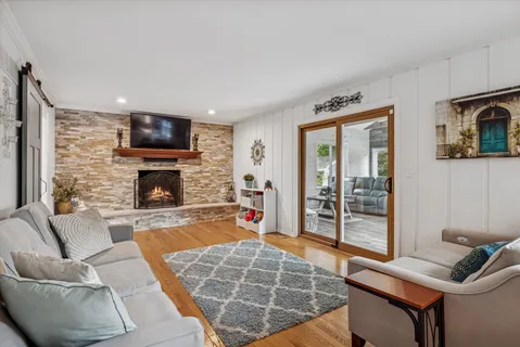 a living room with furniture a flat screen tv and a fireplace
