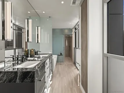 a bathroom with a granite countertop sink a toilet and shower
