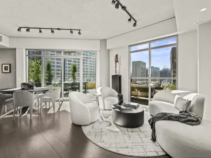 a living room with furniture and a chandelier