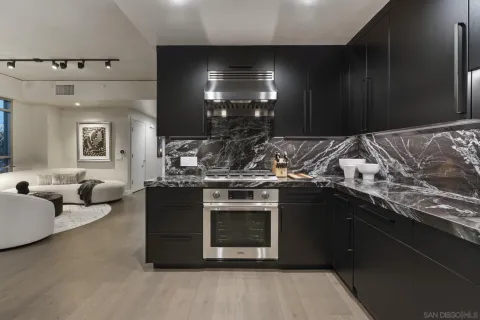 a bedroom with furniture a flat screen tv and a large window