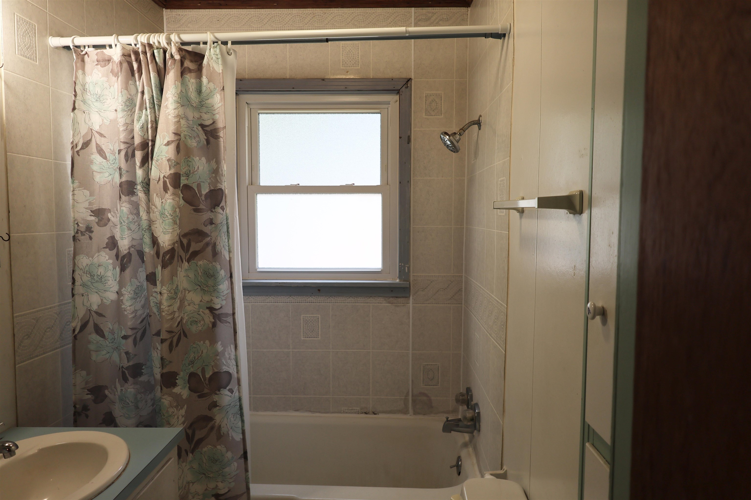 123 North Magnolia Street Adamsville, TN 38310 - Photo 20 of 25 a bathroom with a shower curtain and a sink