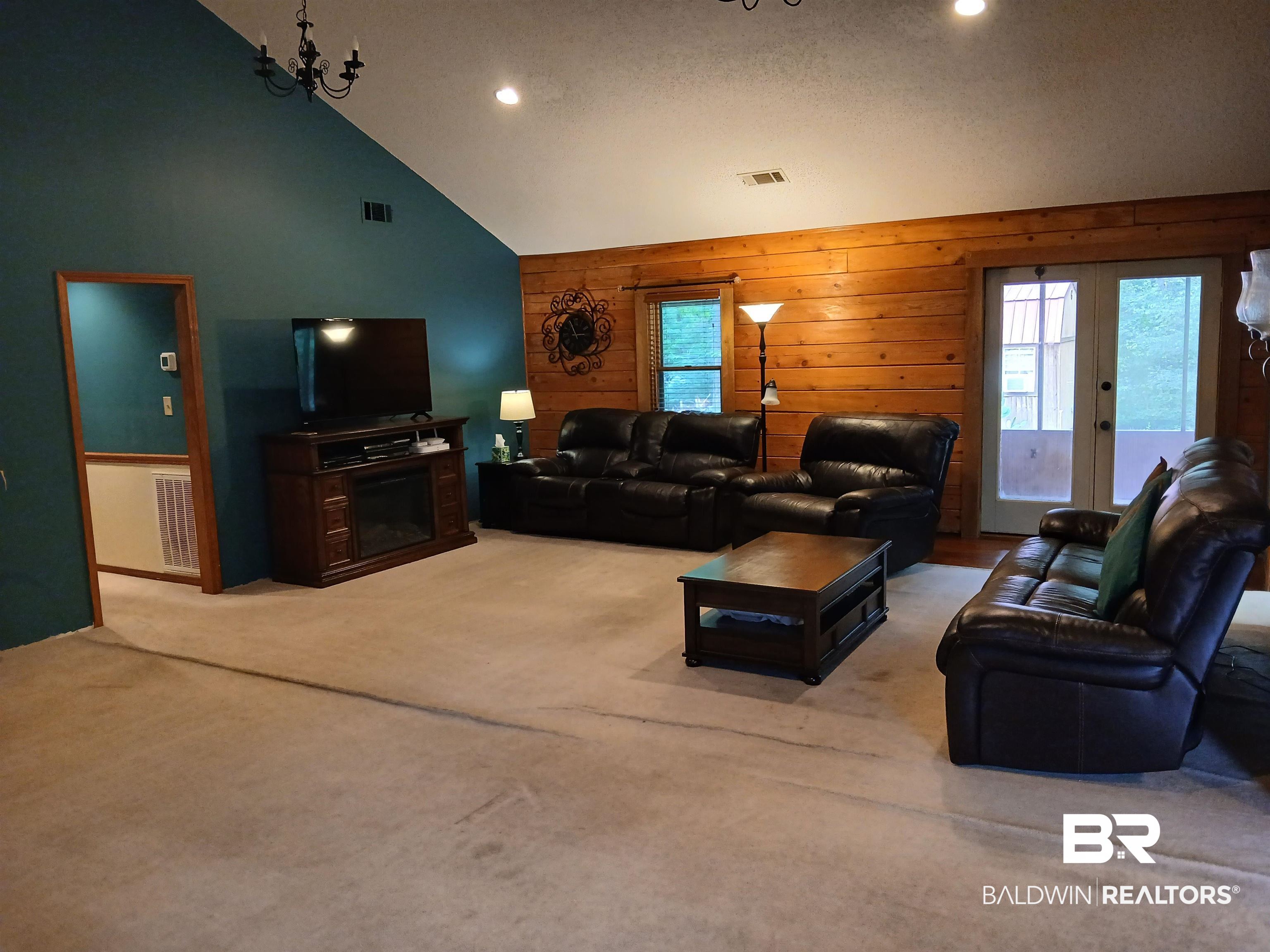 190 Magnolia Court Axis, AL 36505 - Photo 13 of 28 Living room with carpet flooring, high vaulted ceiling, a fireplace, and plenty of natural light