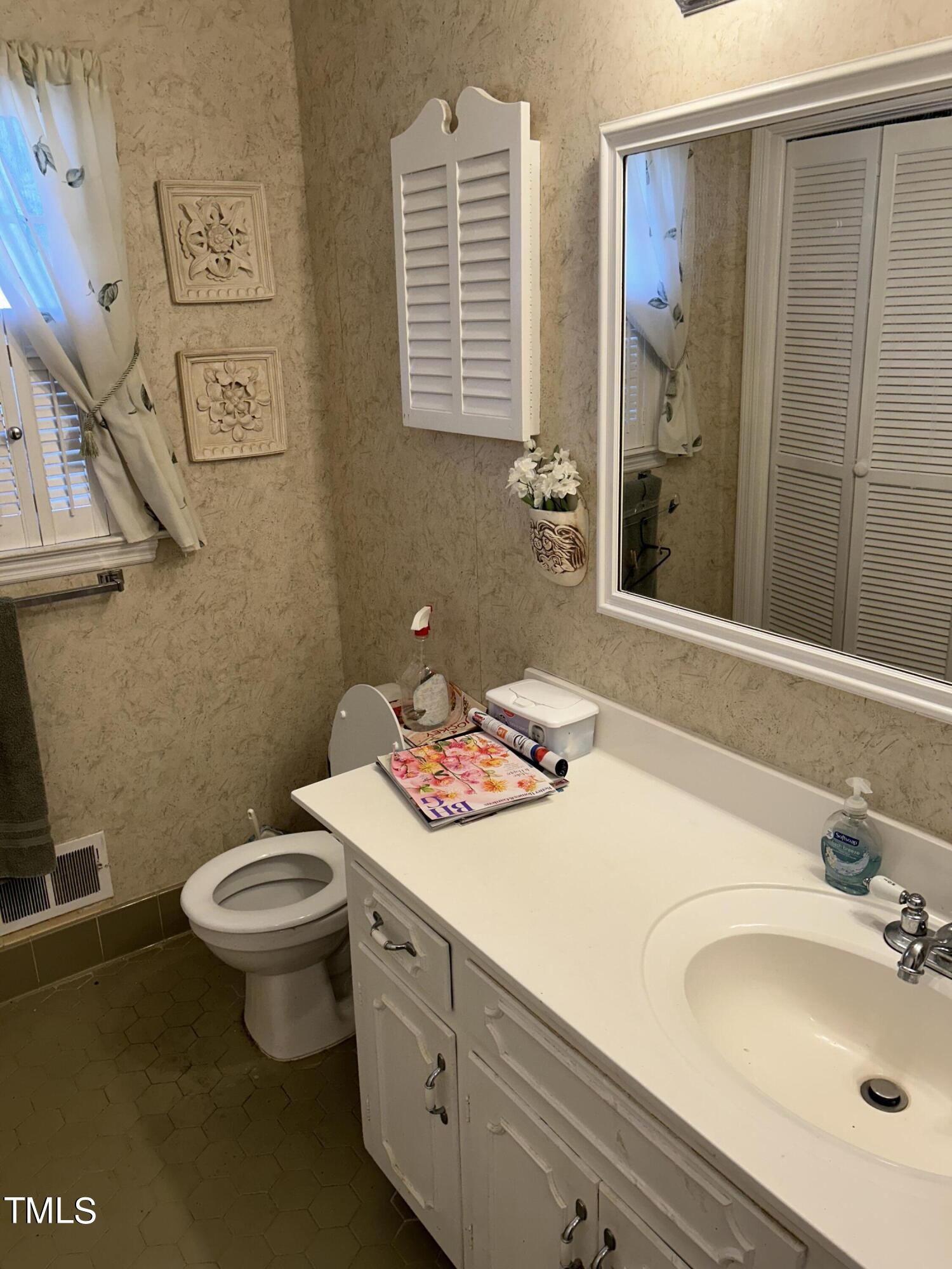 601 Ortega Road Raleigh, NC 27609 - Photo 34 of 36 a bathroom with a sink toilet and shower