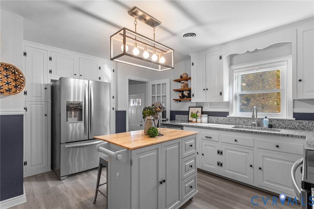 3819 Wakefield Road Richmond, VA 23235 - Photo 16 of 49 a kitchen with a sink refrigerator and cabinets