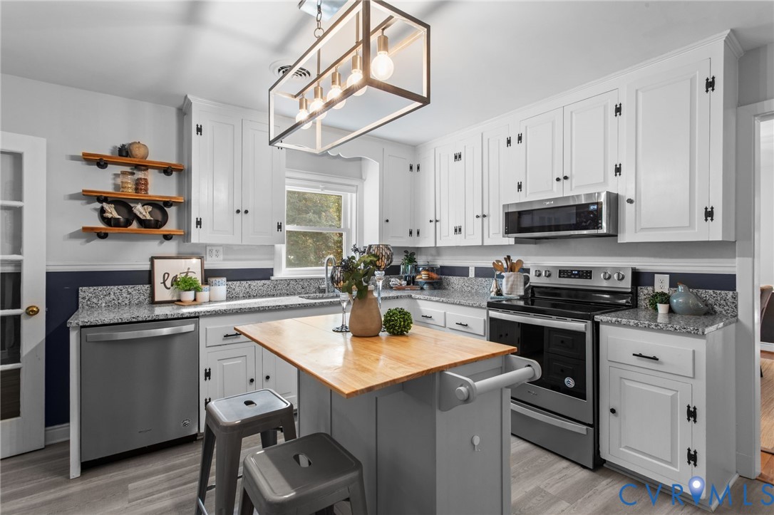 3819 Wakefield Road Richmond, VA 23235 - Photo 17 of 49 a kitchen with stainless steel appliances granite countertop a sink stove and cabinets