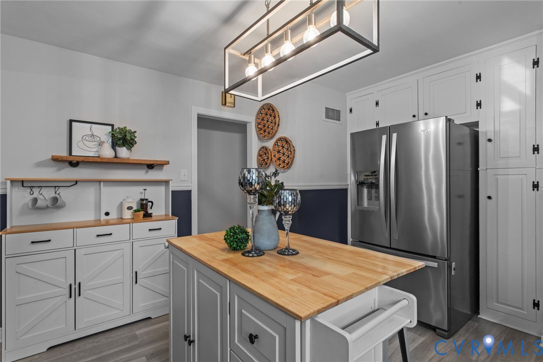 3819 Wakefield Road Richmond, VA 23235 - Photo 19 of 49 a kitchen with stainless steel appliances granite countertop a refrigerator a sink and white cabinets