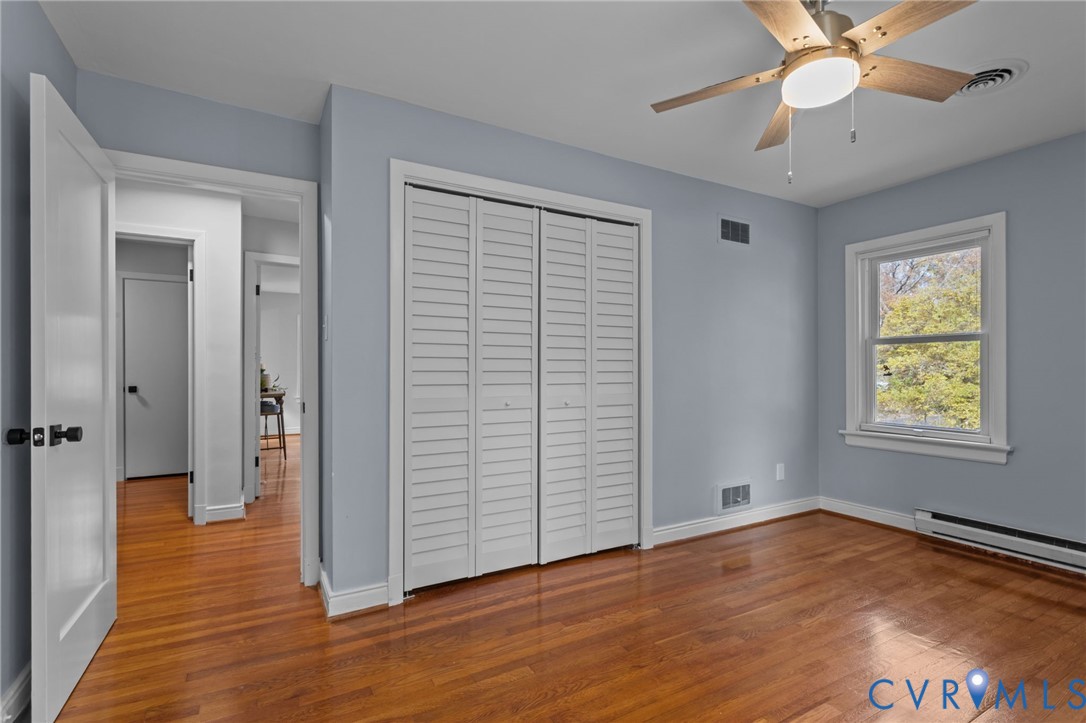 3819 Wakefield Road Richmond, VA 23235 - Photo 25 of 49 an empty room with wooden floor chandelier fan and windows