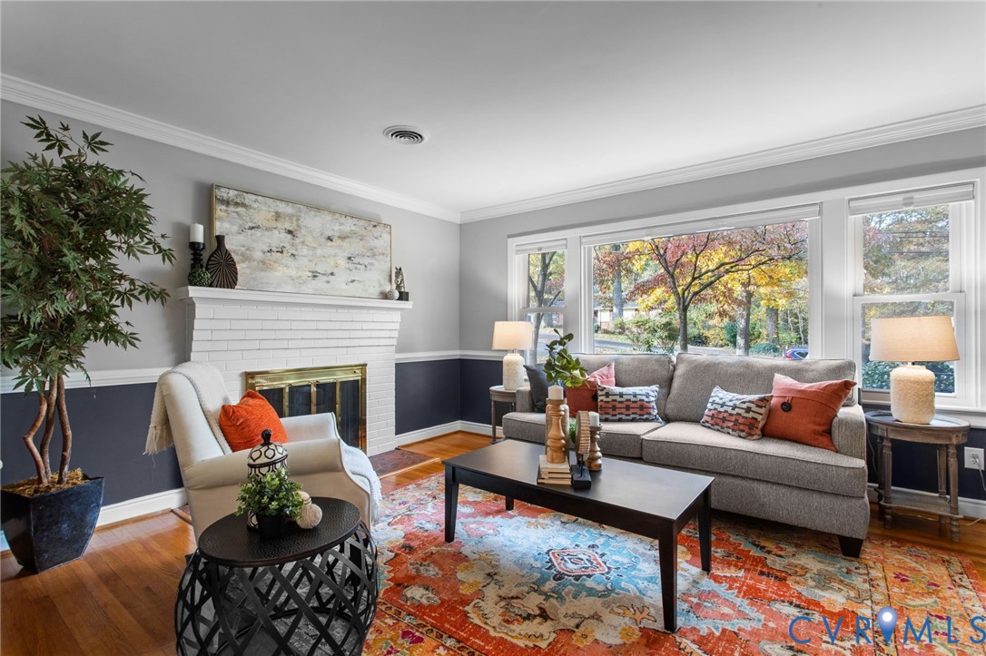 3819 Wakefield Road Richmond, VA 23235 - Photo 4 of 49 a living room with furniture a rug and a fireplace
