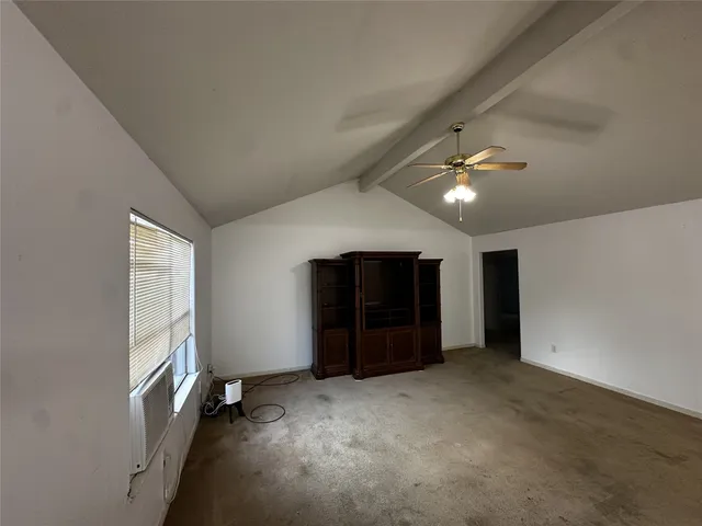 a view of an empty room with a ceiling fan