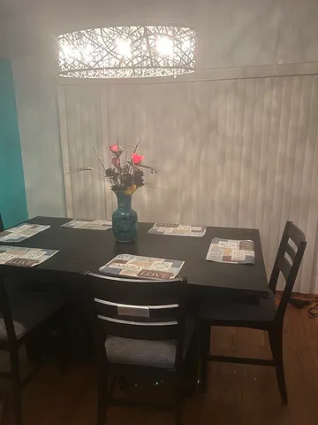a view of a dining room with furniture and chandelier