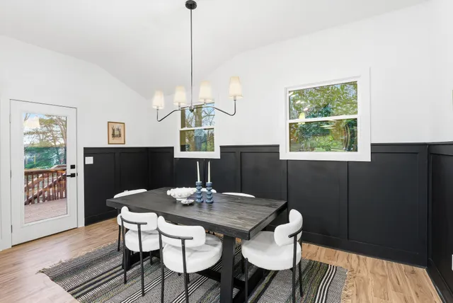 a kitchen with refrigerator cabinets dining table and chairs