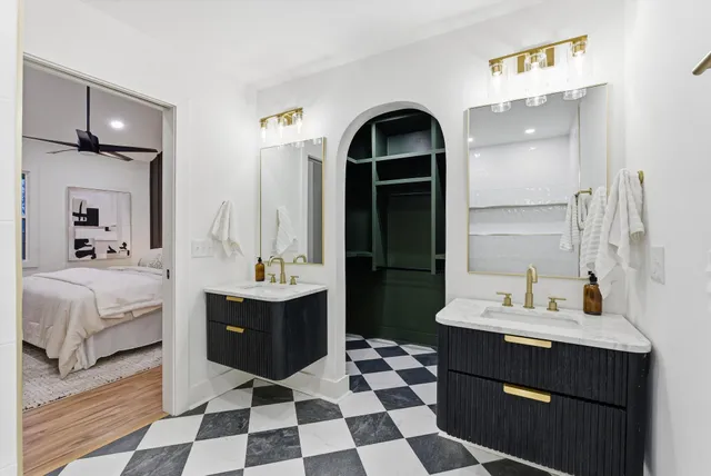 a bathroom with a granite countertop toilet a sink and a mirror
