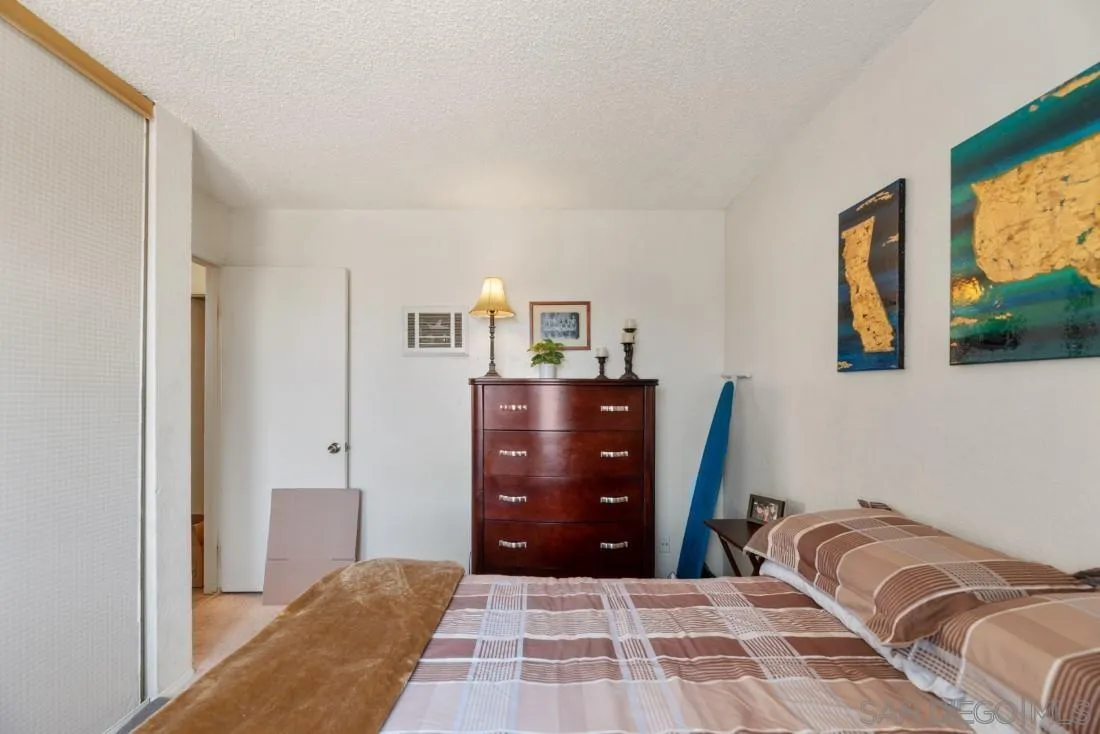 11187 Kelowna Road, Unit 74 San Diego, CA 92126 - Photo 13 of 24 a bedroom with a bed and painting on the wall