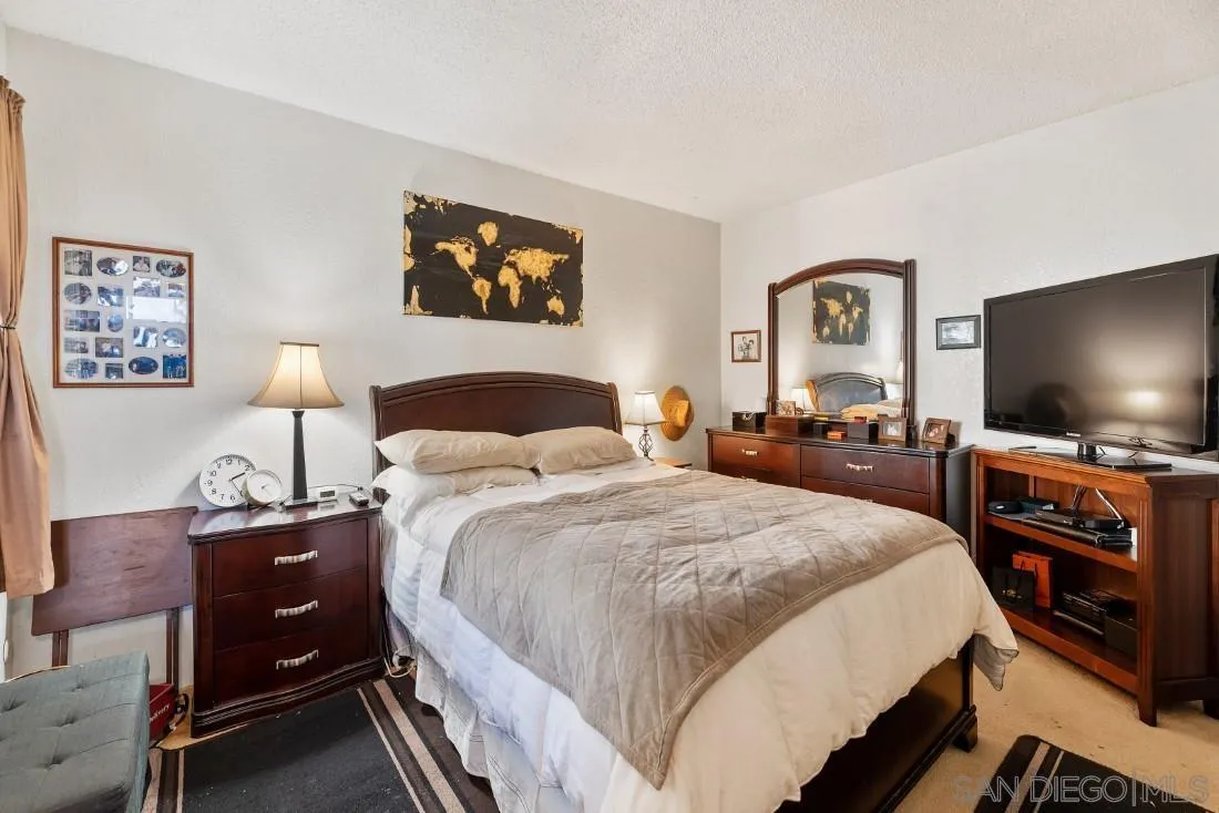 11187 Kelowna Road, Unit 74 San Diego, CA 92126 - Photo 15 of 24 a bedroom with a bed and a flat screen tv