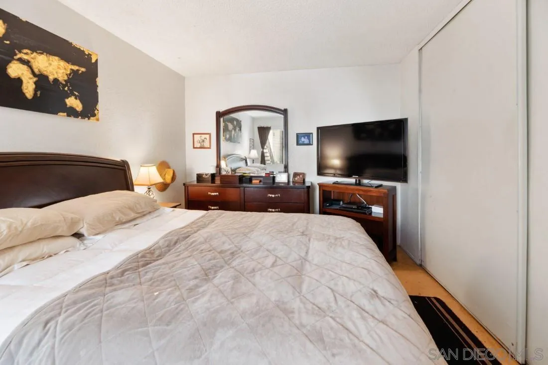 11187 Kelowna Road, Unit 74 San Diego, CA 92126 - Photo 16 of 24 a bedroom with a bed and a flat screen tv