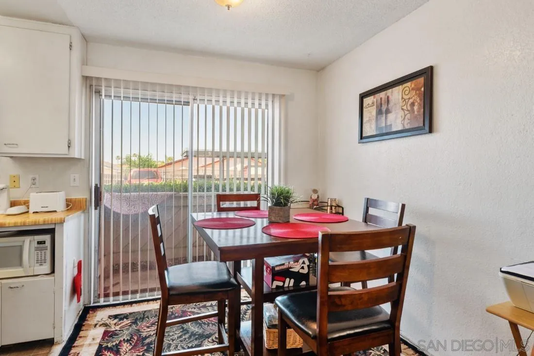 11187 Kelowna Road, Unit 74 San Diego, CA 92126 - Photo 7 of 24 a dining room with furniture and window