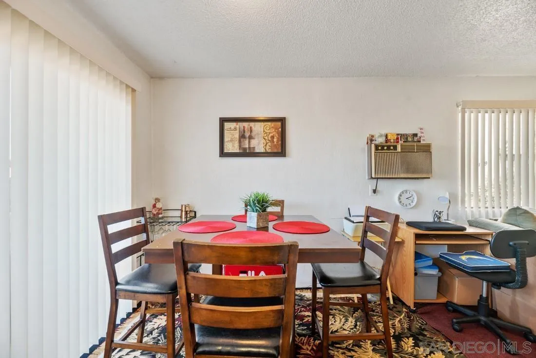 11187 Kelowna Road, Unit 74 San Diego, CA 92126 - Photo 8 of 24 a view of a dining room with furniture and chandelier