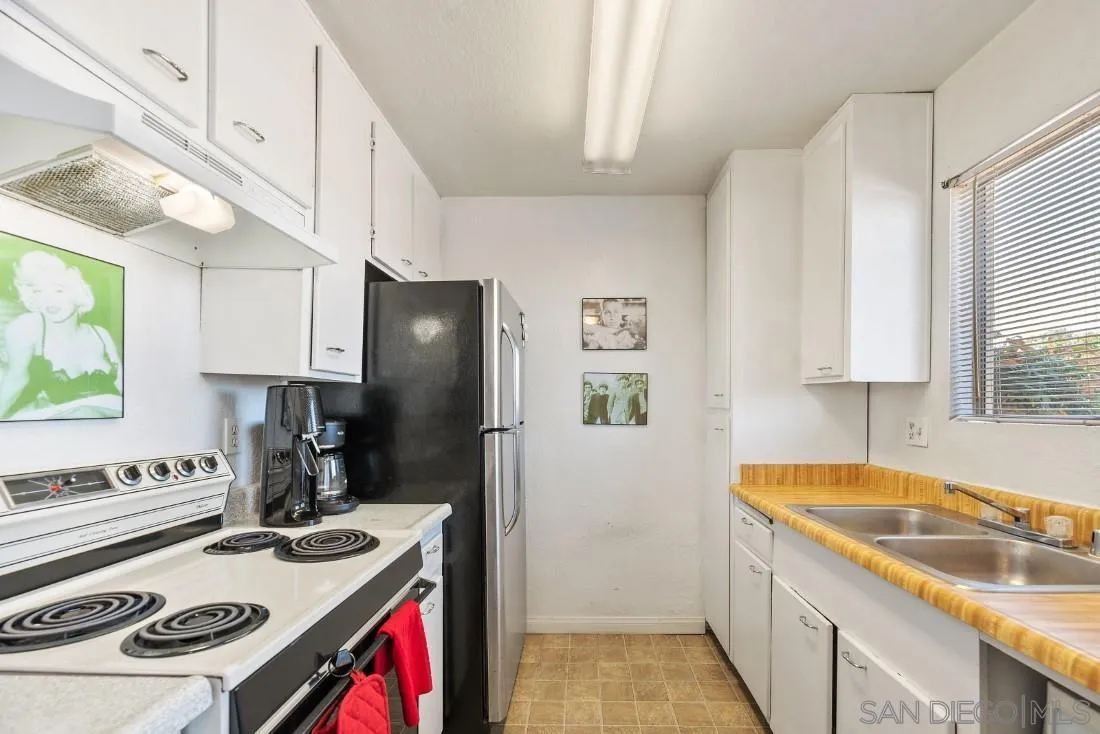 11187 Kelowna Road, Unit 74 San Diego, CA 92126 - Photo 10 of 24 a kitchen with stainless steel appliances granite countertop a sink stove and refrigerator