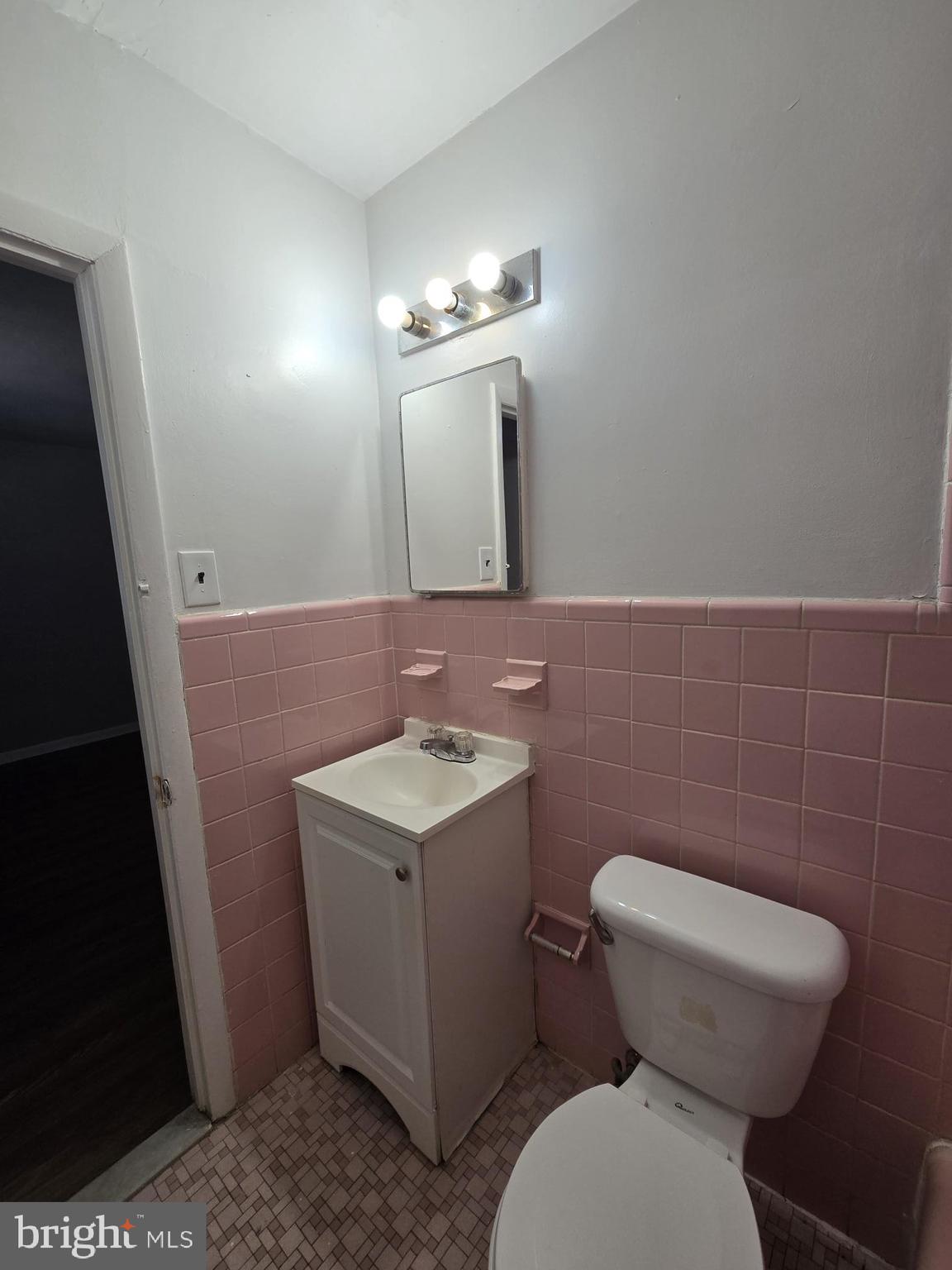 5302 Duffield Street Philadelphia, PA 19124 - Photo 7 of 11 a bathroom with a toilet a sink and mirror