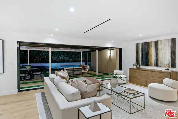 a large white kitchen with a large window