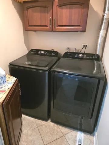 a utility room with granite countertop a sink and a stove