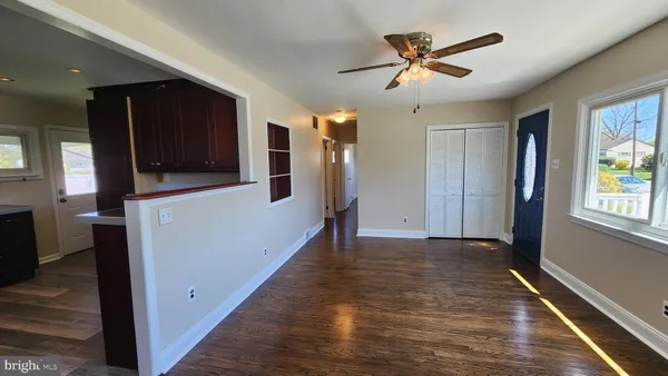 a view of a livingroom with a ceiling fan and a window