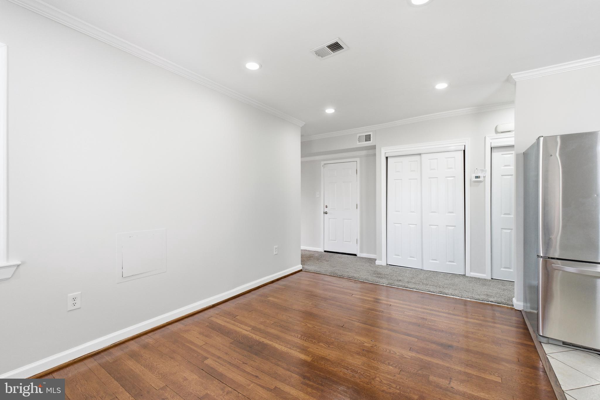 2712 6th Street Northeast Washington, DC 20017 - Photo 8 of 24 a view of an empty room with wooden floor and a refrigerator
