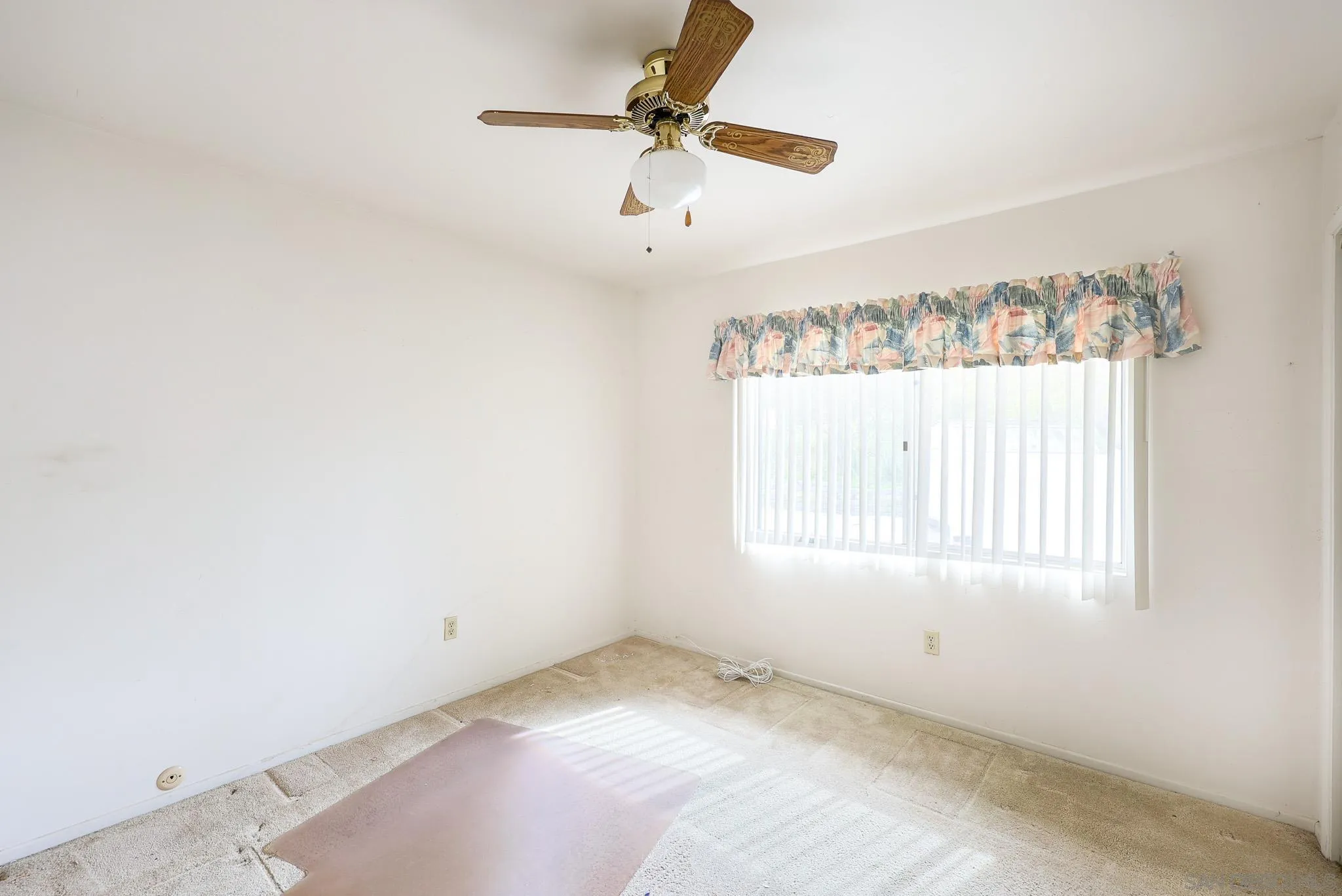 221 Colina Terrace Vista, CA 92084 - Photo 32 of 57 an empty room with a window and a fan