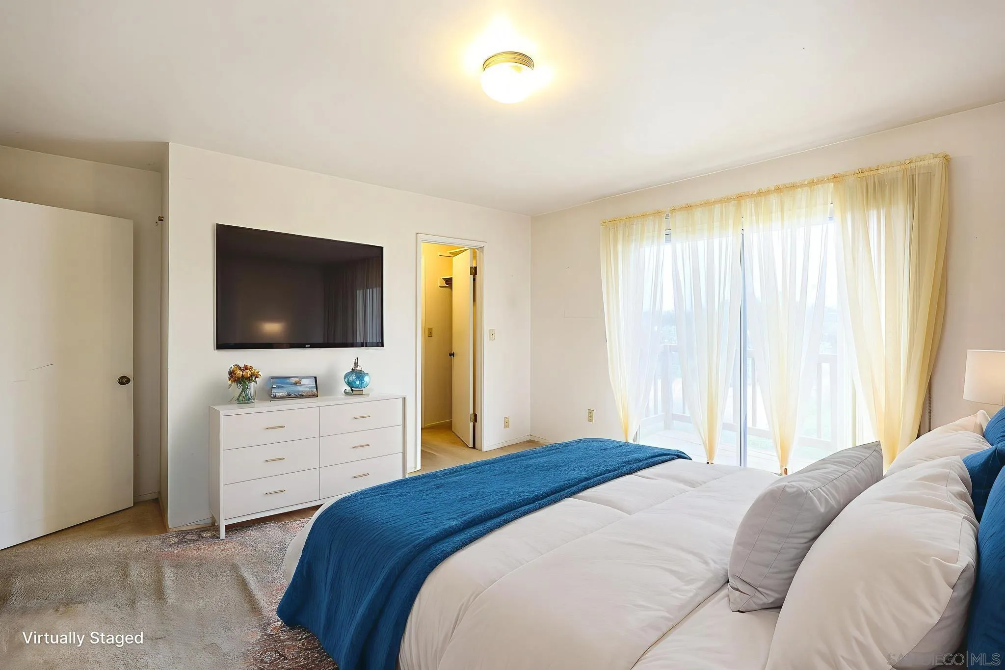 221 Colina Terrace Vista, CA 92084 - Photo 36 of 57 a bedroom with a large bed and a flat screen tv