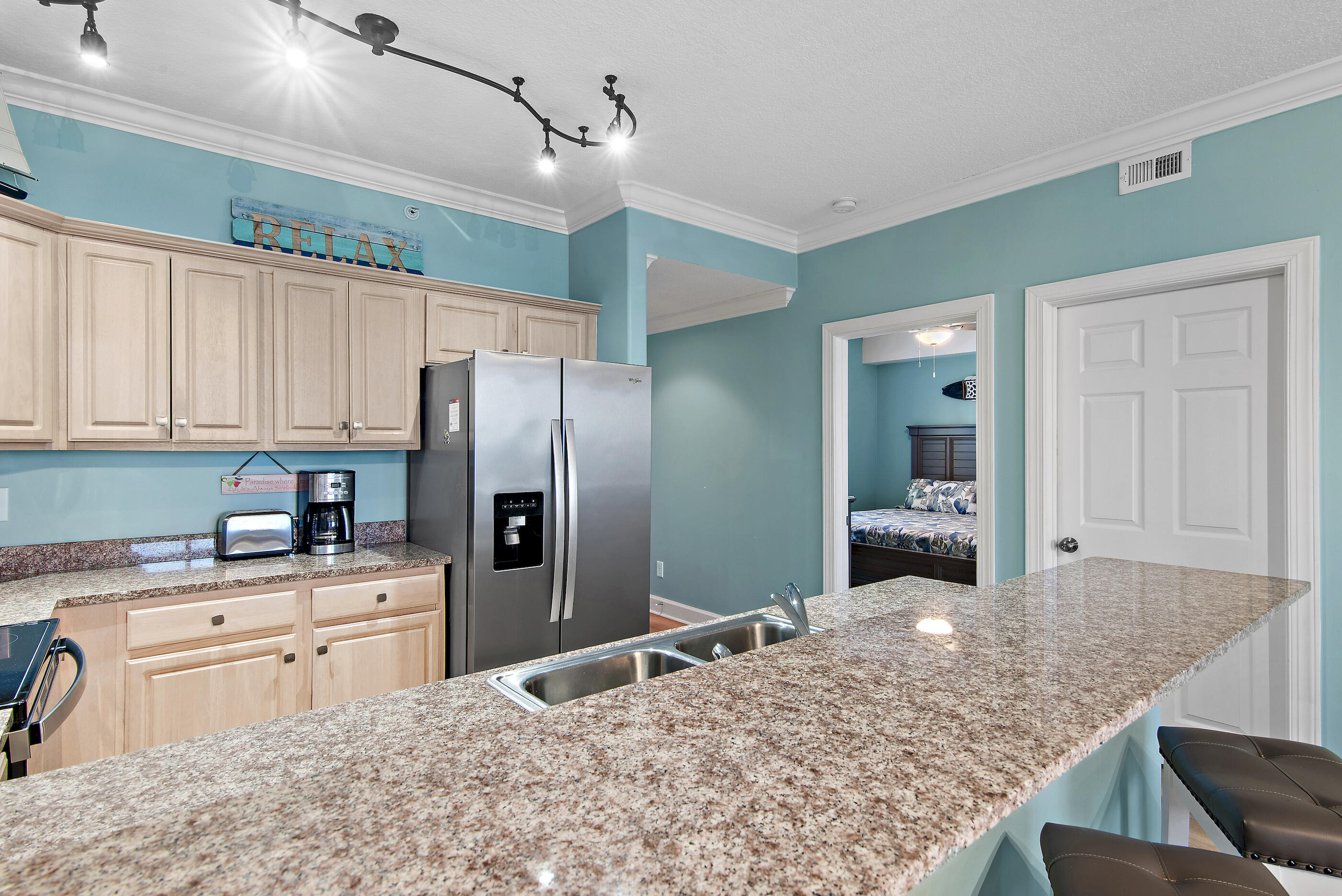 17545 Front Beach Road, Unit 1104 Panama City Beach, FL 32413 - Photo 15 of 31 a kitchen with stainless steel appliances granite countertop a sink refrigerator and cabinets