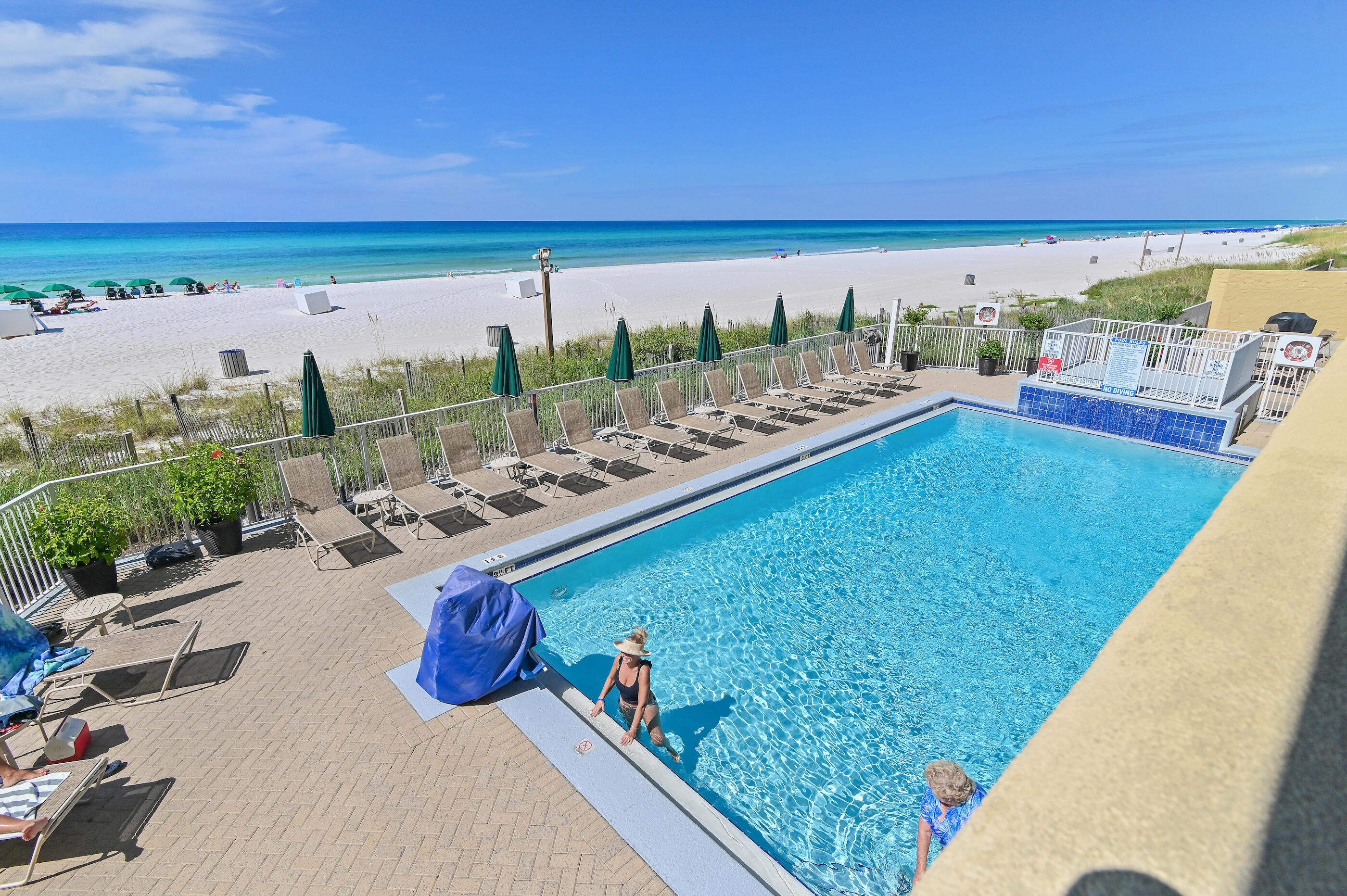 17545 Front Beach Road, Unit 1104 Panama City Beach, FL 32413 - Photo 21 of 31 a view of a swimming pool and lounge chair