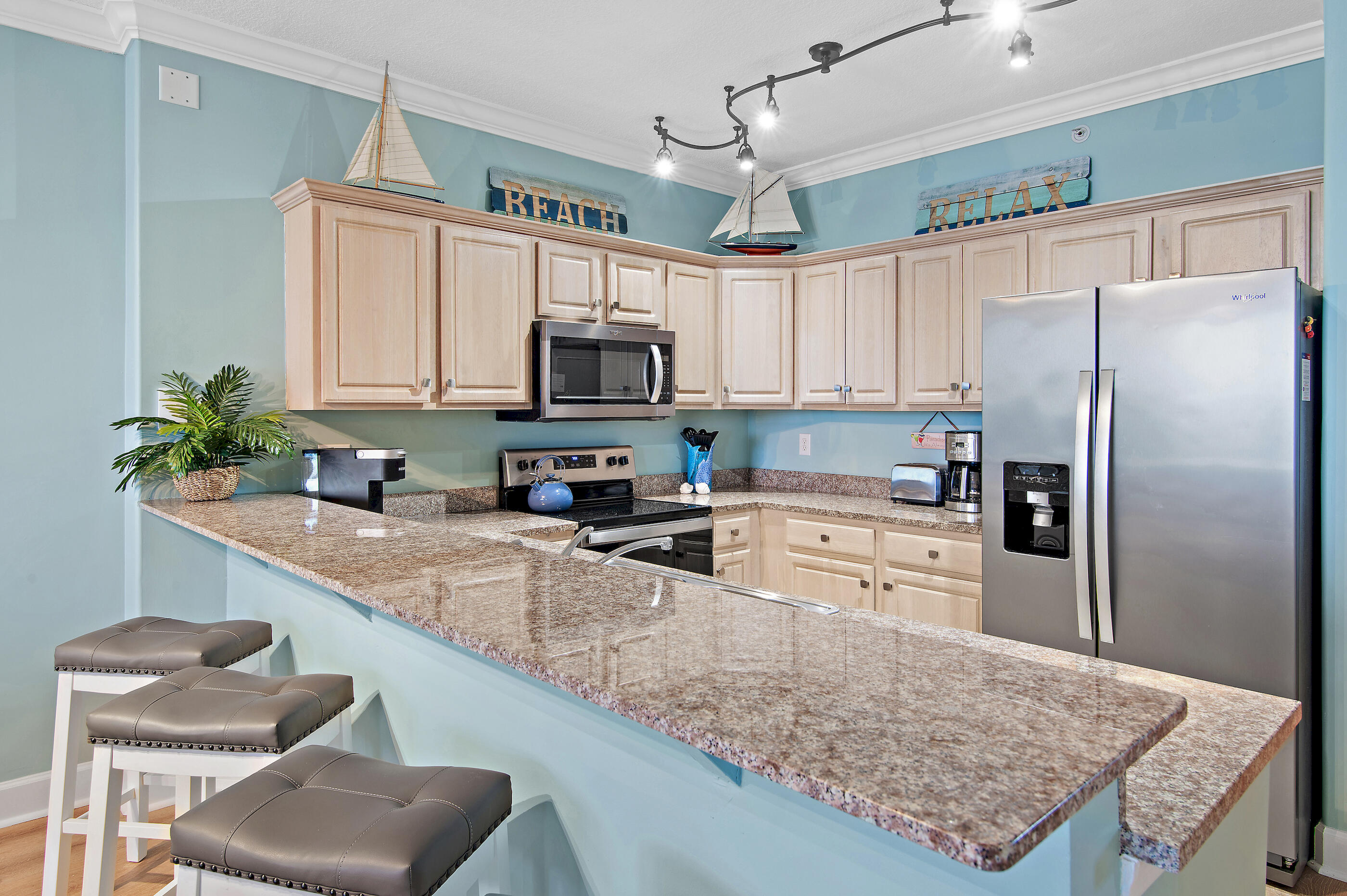 17545 Front Beach Road, Unit 1104 Panama City Beach, FL 32413 - Photo 3 of 31 a kitchen with stainless steel appliances granite countertop a sink refrigerator stove microwave and cabinets
