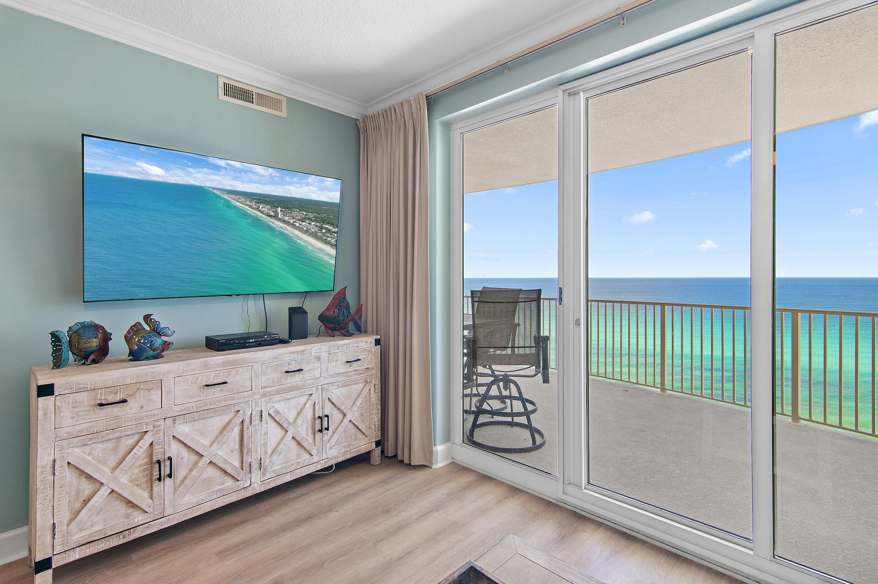 17545 Front Beach Road, Unit 1104 Panama City Beach, FL 32413 - Photo 8 of 31 a bedroom with a large window and a chandelier