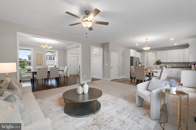 a living room with furniture and a dining table