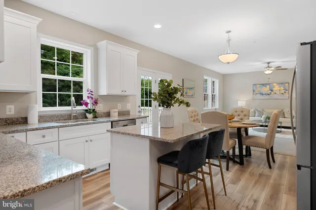 a kitchen with a table chairs sink and cabinets
