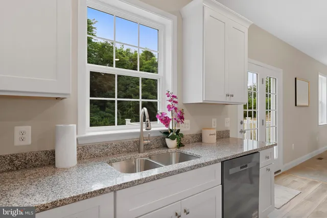 a kitchen with granite countertop a sink and a window