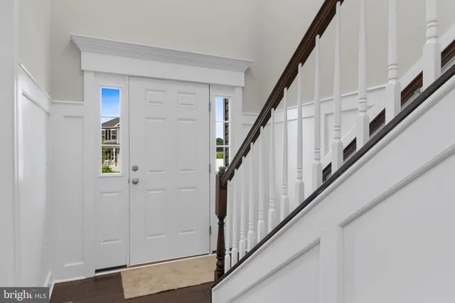 a view of staircase with lots of frames on wall and stairs
