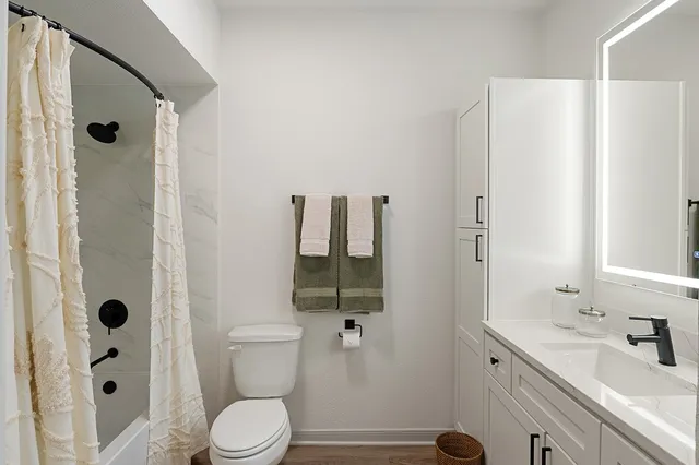 a bathroom with a sink toilet and shower