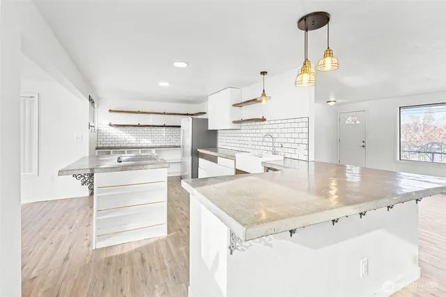 a kitchen with a sink stainless steel appliances and cabinets