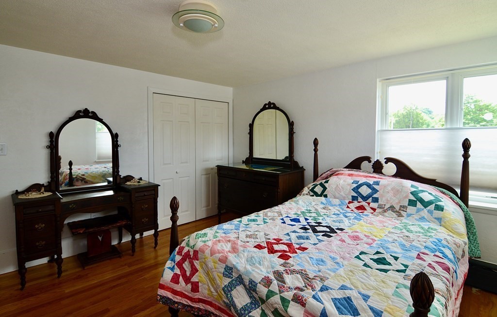 53 Harborview Road Hull, MA 02045 - Photo 16 of 21 a bedroom with a bed and a dresser