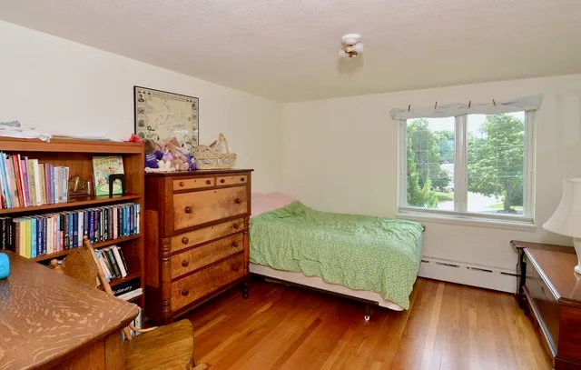 a living room with furniture and a book shelf