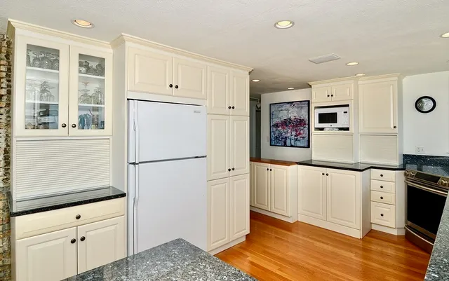 a kitchen with stainless steel appliances a refrigerator sink and cabinets