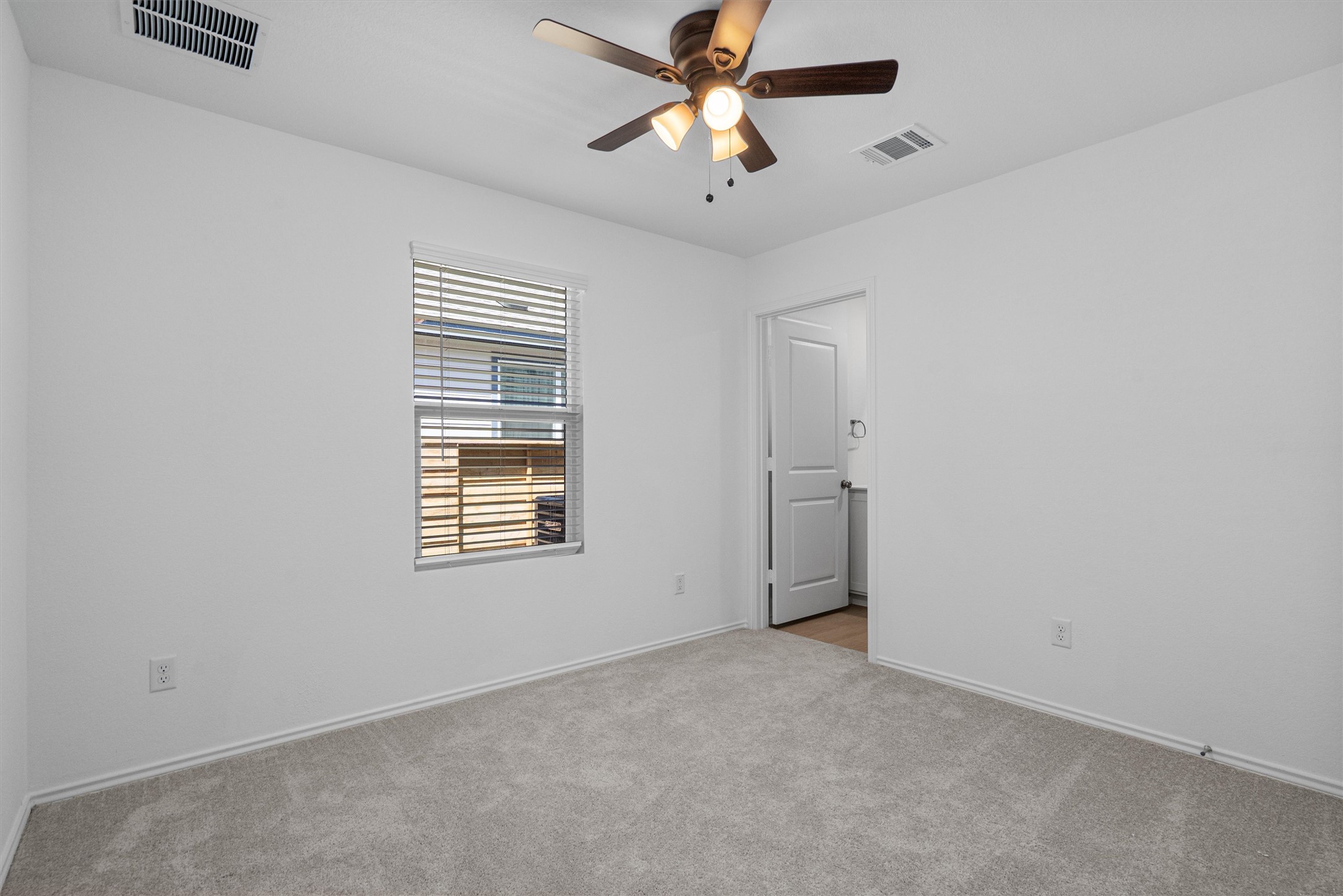 3305 Everett Kyle, TX 78640 - Photo 14 of 21 Guest bedroom with light carpet and ceiling fan