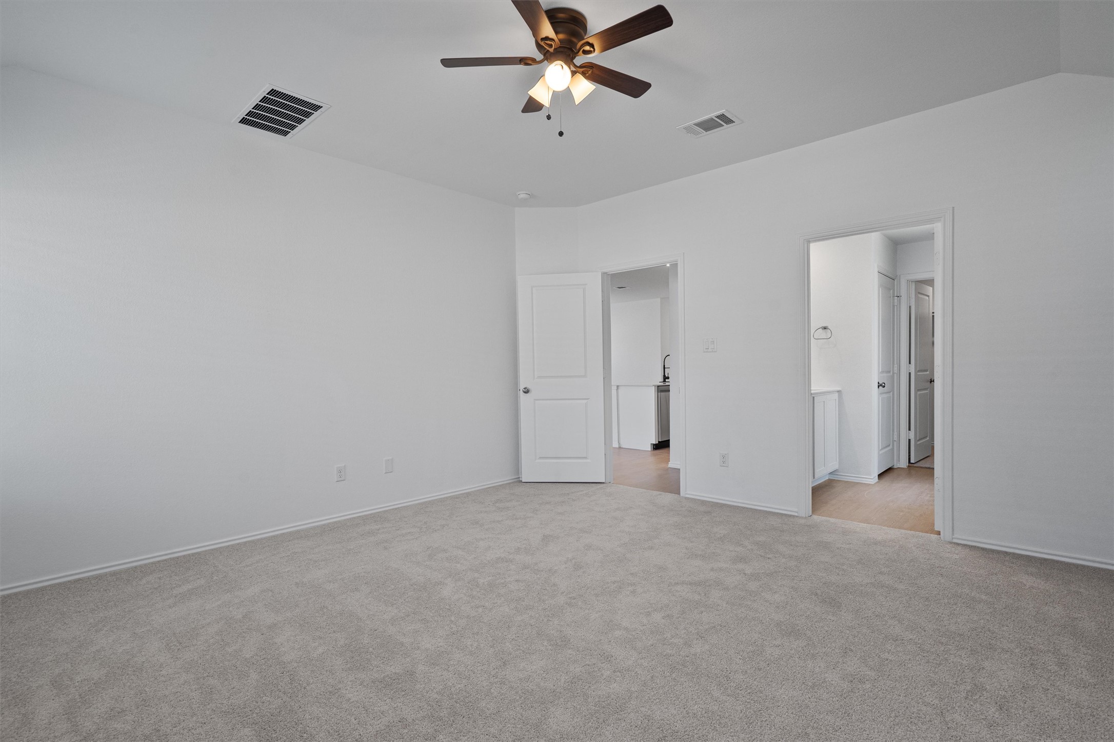 3305 Everett Kyle, TX 78640 - Photo 15 of 21 Great size primary bedroom featuring light carpet and a ceiling fan